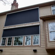 Retractable solar screen wall added on to large windows to block/protect the home from the west sun