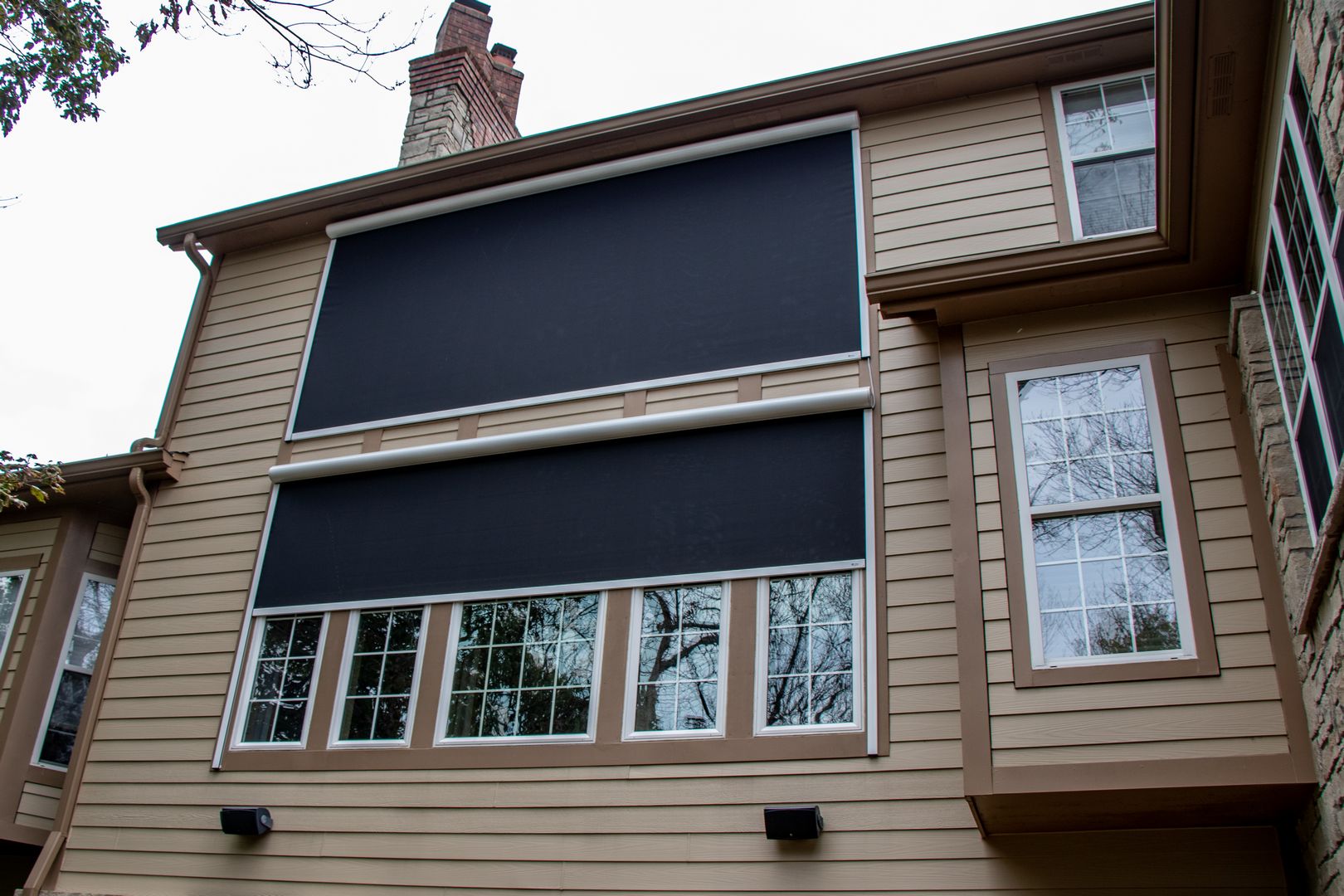 Retractable solar screen wall added on to large windows to block/protect the home from the west sun