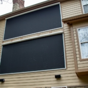 Retractable solar screen wall added on to large windows to block/protect the home from the west sun