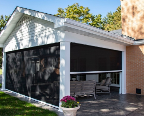 An outdoor room addition with three retractable screen walls