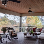 The interior of an outdoor screen room addition on a composite deck