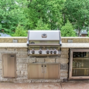 custom built in napoleon grill with a true refrigerator and stainless steel cabinets