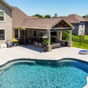 A custom unique outdoor pool house. This pool house includes a Fireplace with sitting walls on either side and stone accents.