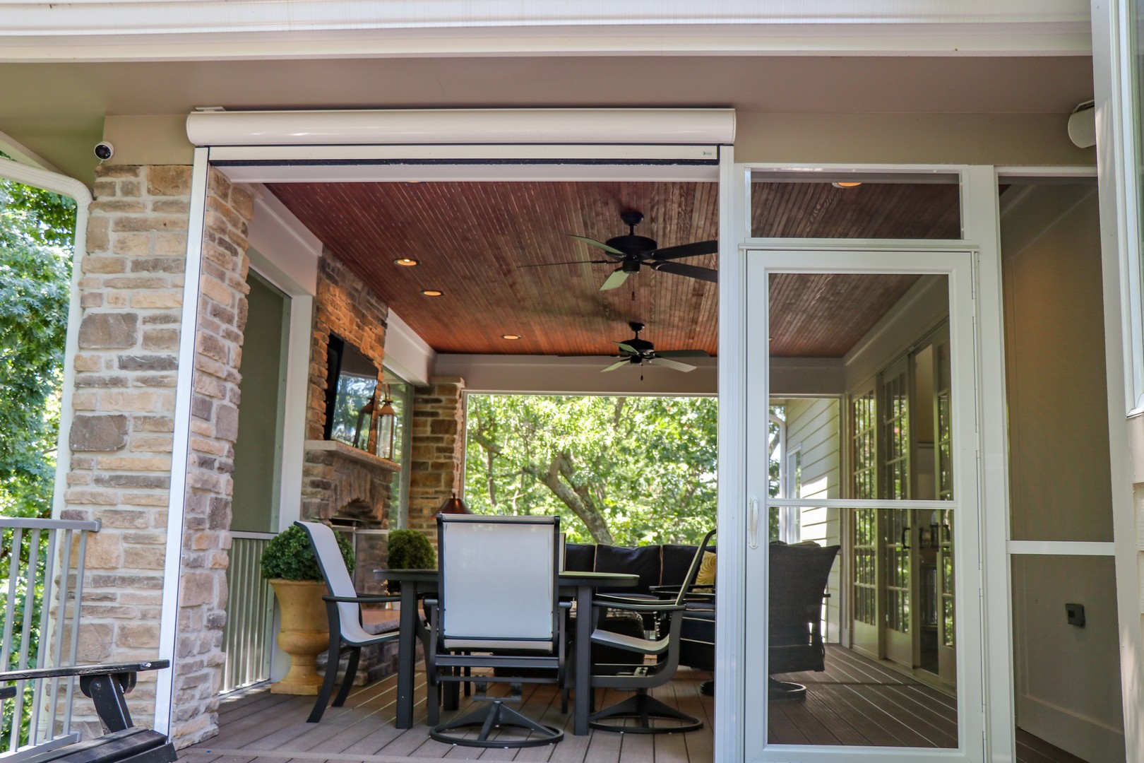 enjoy a family dinner in an outdoor room with retractable screens