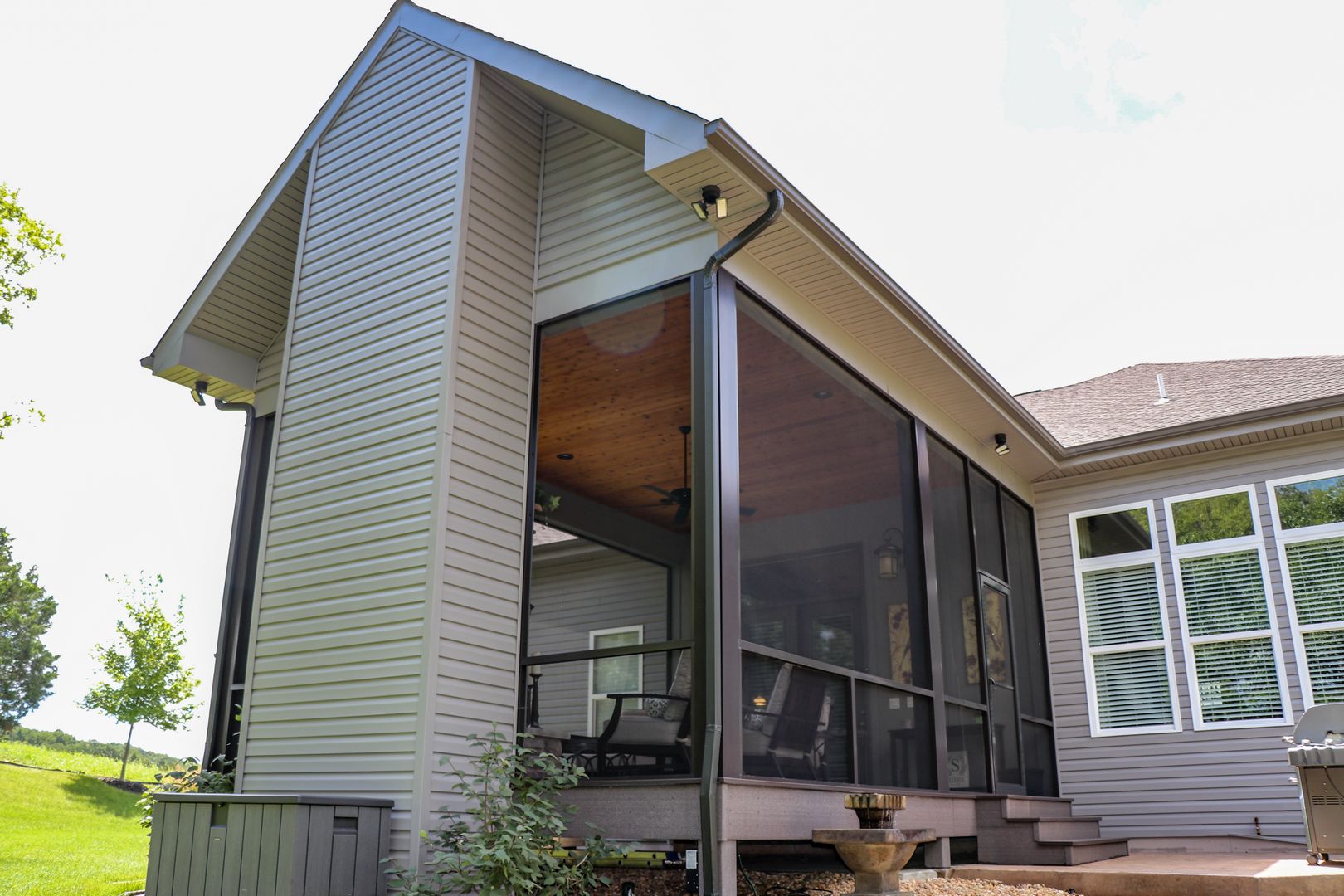 Covered screen room that helps contain heat from the fireplace