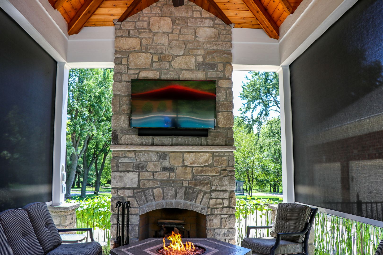 Fireplace with retractable screens that help provide warmth during the cooler seasons