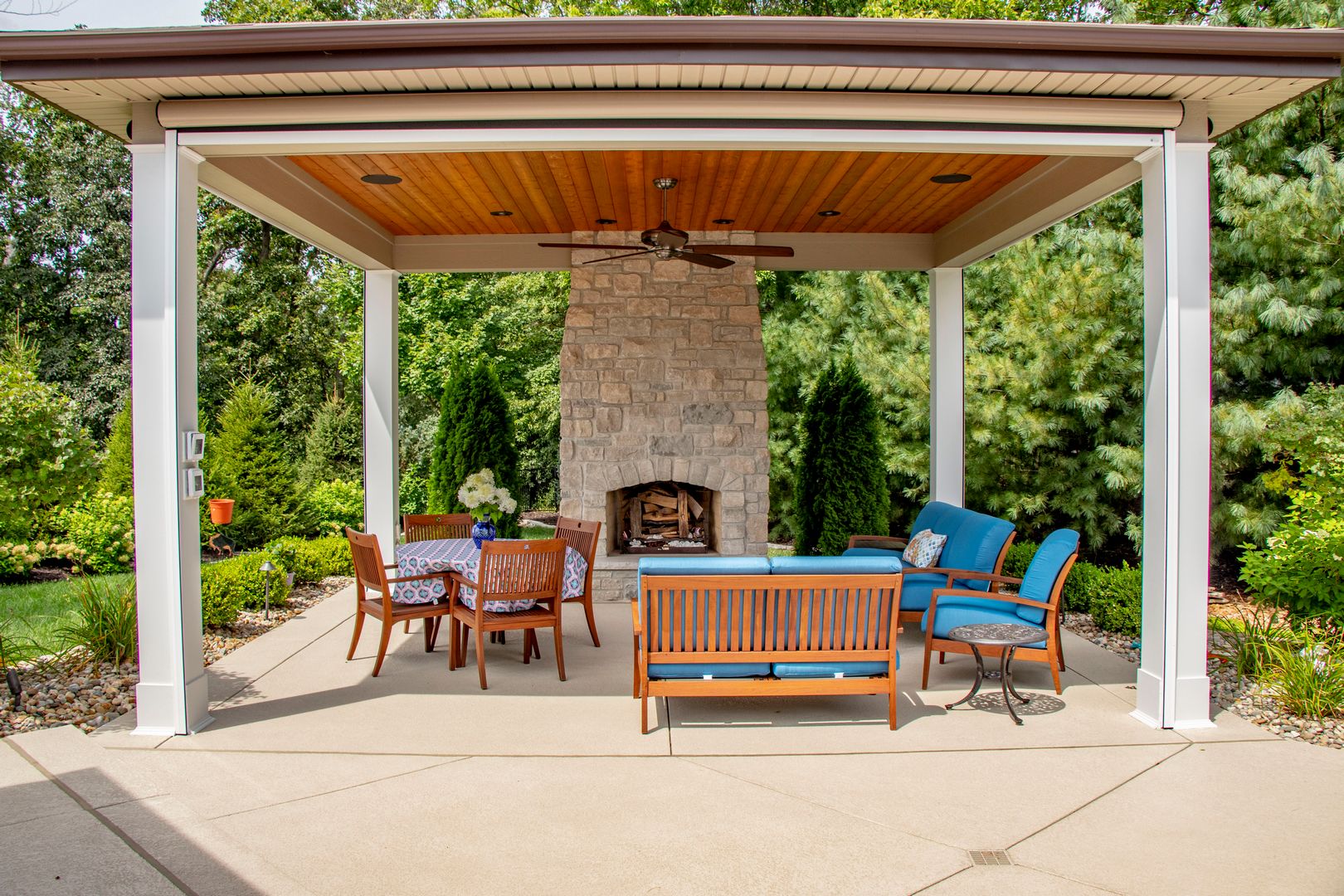 Comfortable seating in a fully retractable screen room that includes a fireplace