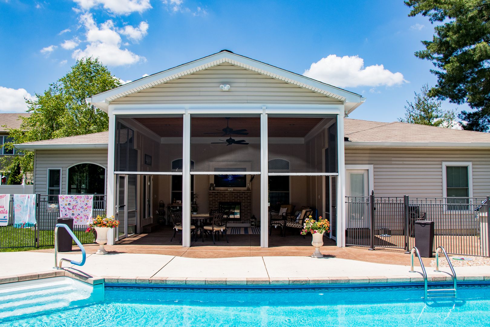 Retractable screen by a pool