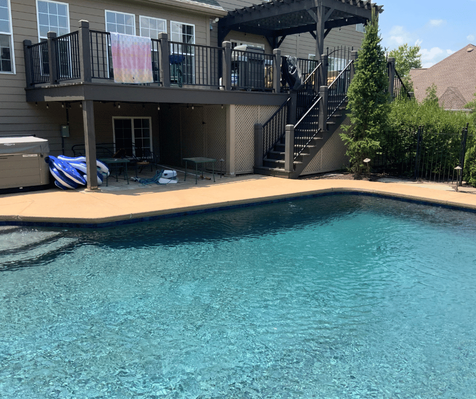 before photo of the multi level outdoor room with a two tiered fireplace